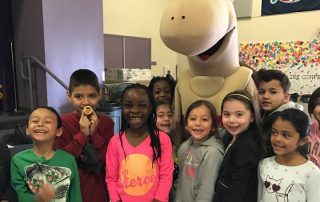 Group of happy school children with Mojave Max mascot